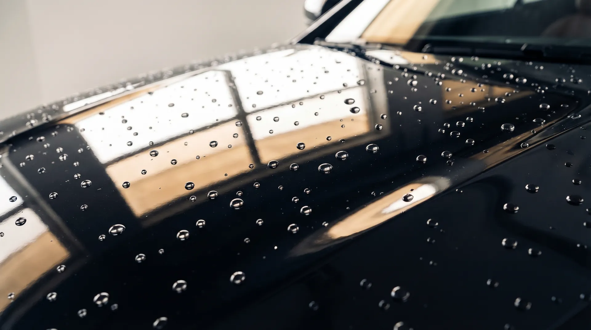 Mirror-finish car hood after ceramic coating with water beading